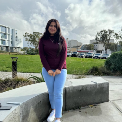 Annu standing near next to the rock bench